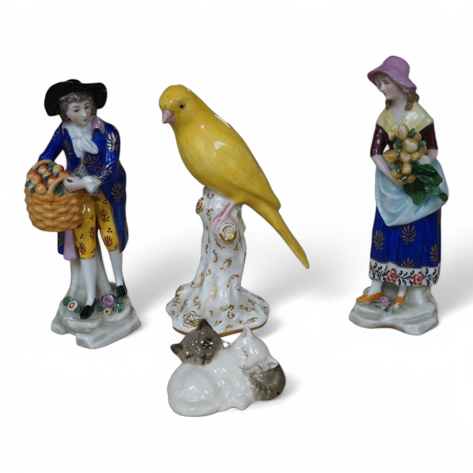 A small group of mixed ceramics to include a Royal Worcester model of a canary, No 2665, a Royal Doulton ‘cat’ group and a pair of continental figures. Tallest 16cm. Condition - mostly good